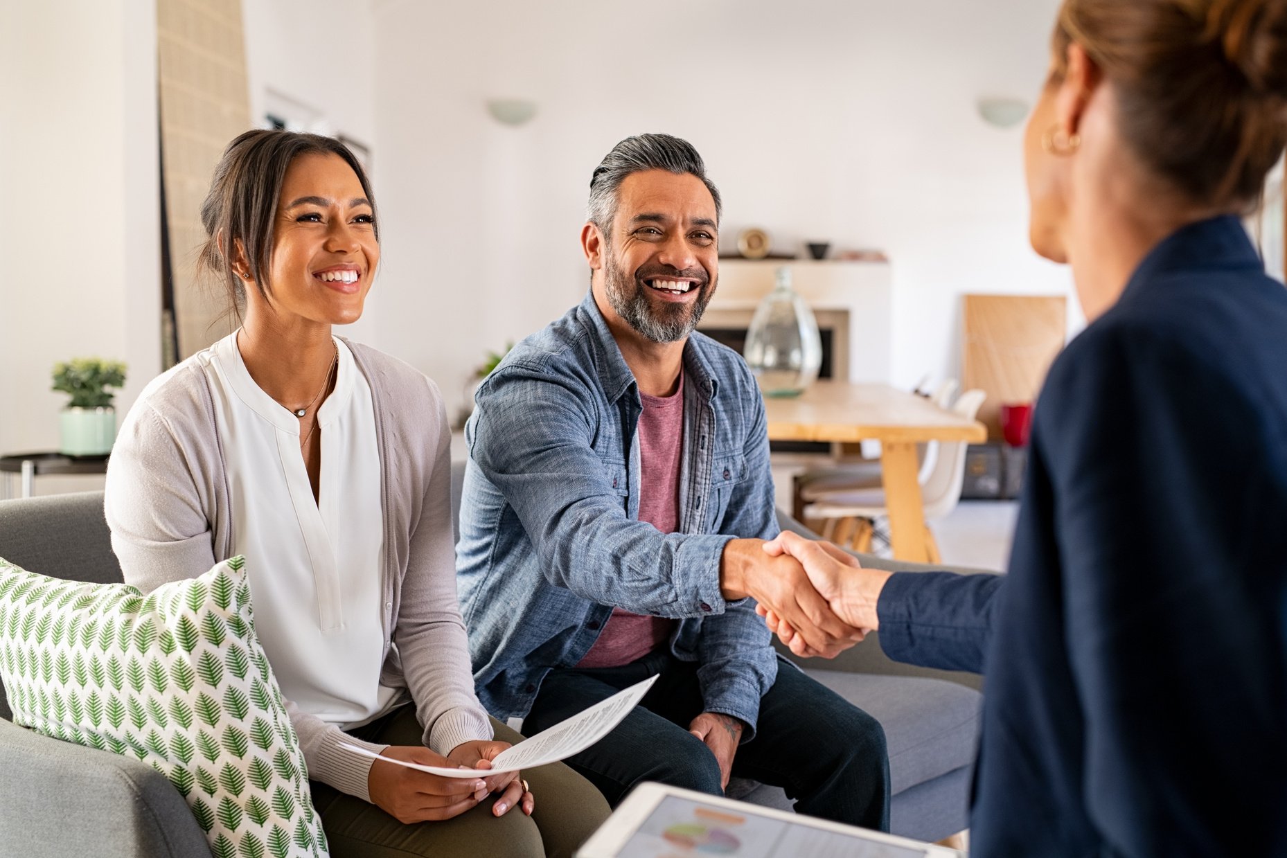 Couple Handshaking with Consultant at Home