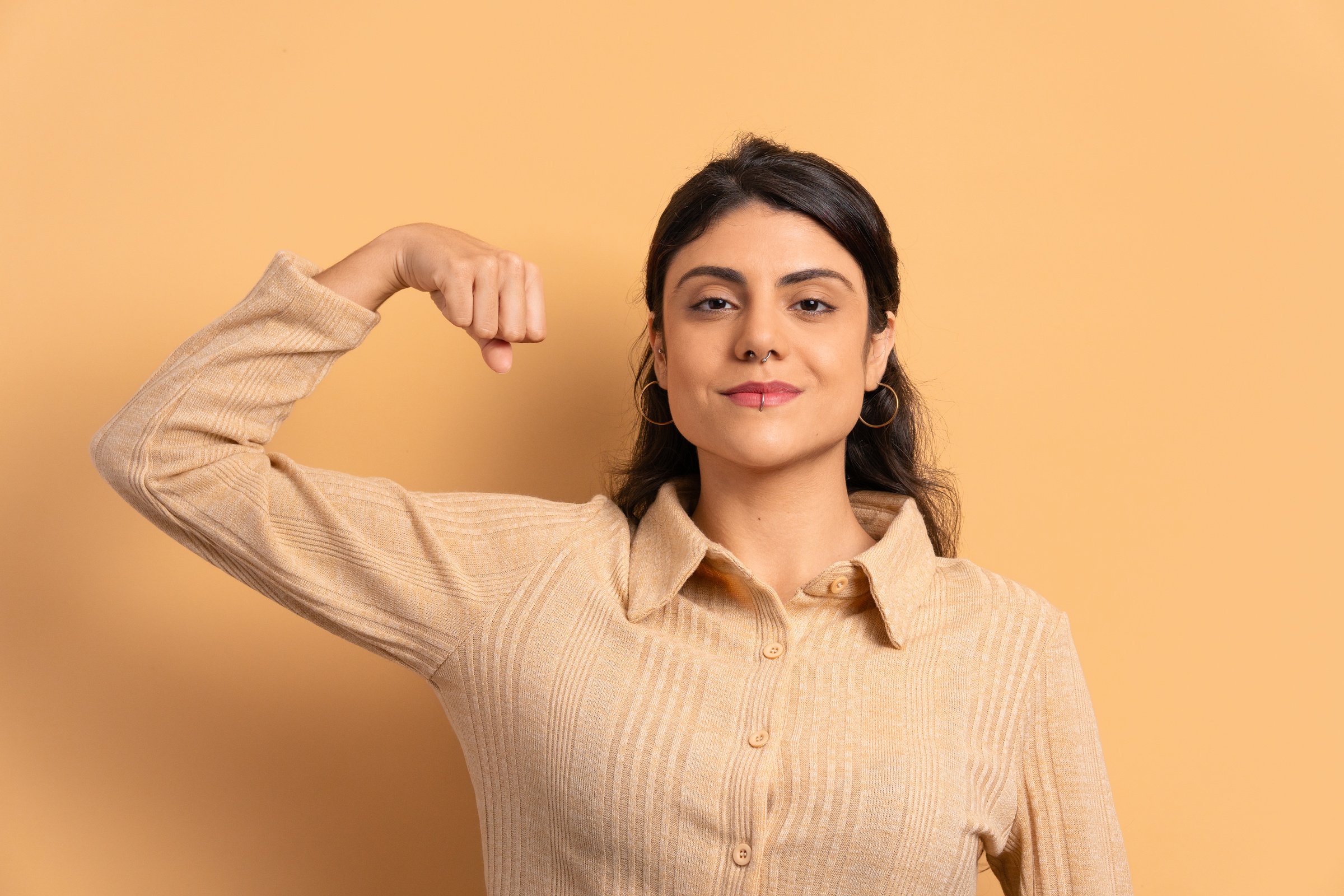 confident woman flexing arms