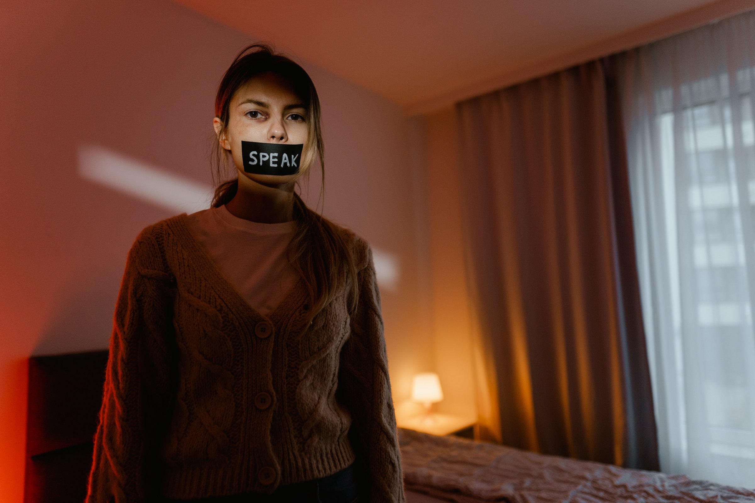 A Woman with Black Tape on Her Mouth Looking at the Camera